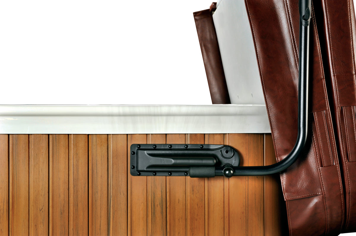 A black cover lift system attached to a wooden spa cover, designed to lift and cover the spa.