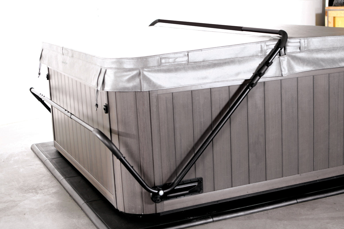 A gray CoverMate II spa cover with aluminum tubing and mounting brackets, designed to rest low on a spa for less-obstructed view.